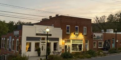Small town main street with shops at sunset.