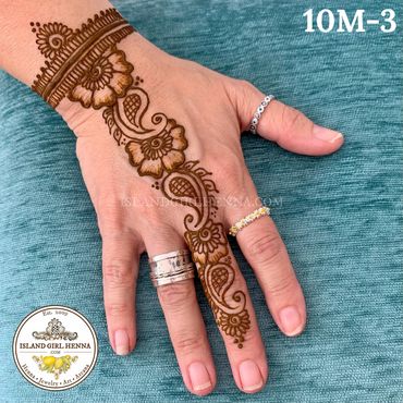 Intricate henna design on hand with floral and paisley patterns.