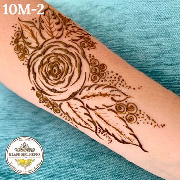 Henna tattoo of a rose with leaves on forearm.