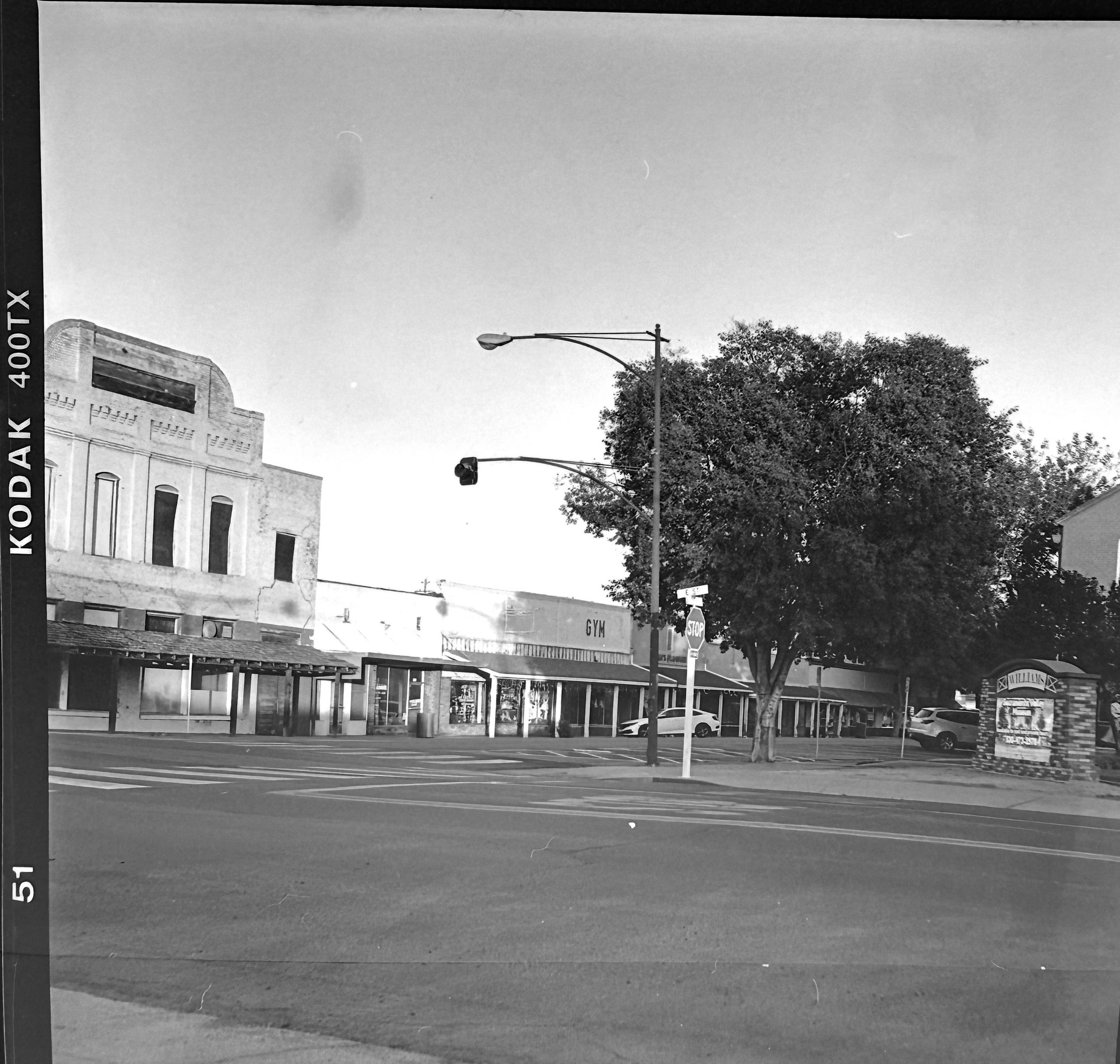 Black and white photo of a street corner with old buildings.