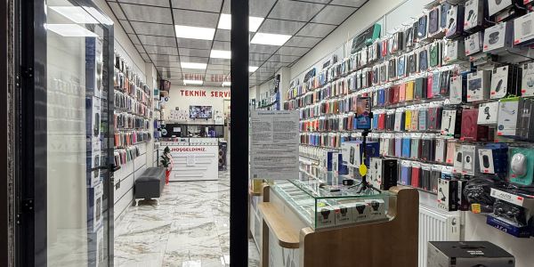 Mobile phone accessories and repair shop interior with many phone cases on display.