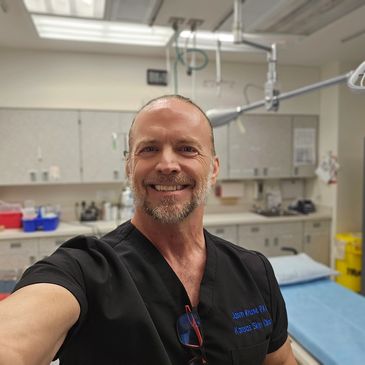 Smiling healthcare professional in a hospital room.