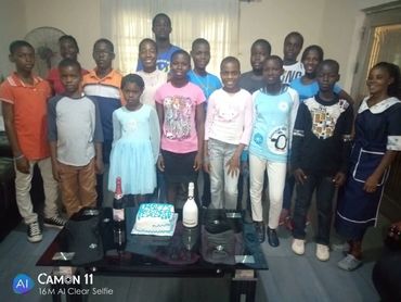 Children by the birthday cake.