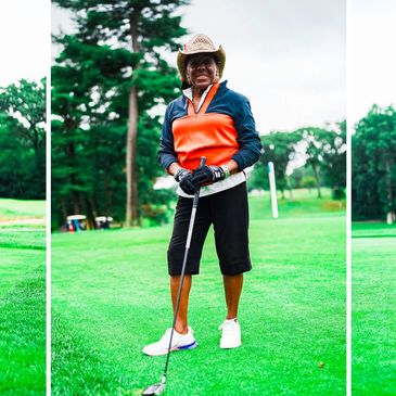 Person in a cowboy hat playing golf on a green course.