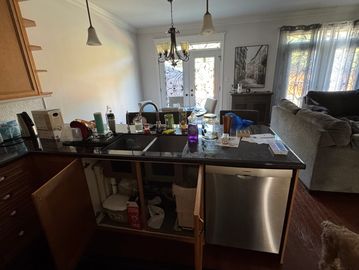 Kitchen island with open cabinets and various items on the countertop.