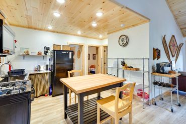 sturdy wooden table, and a flickering wood-burning stove.