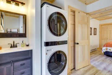 Natural wood ceiling and butcher block island in a charming cabin kitchen.