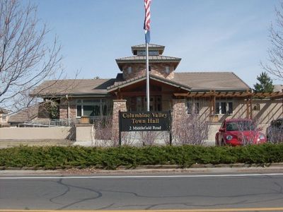 A Building With a Flag Post and an American Flag in the Front