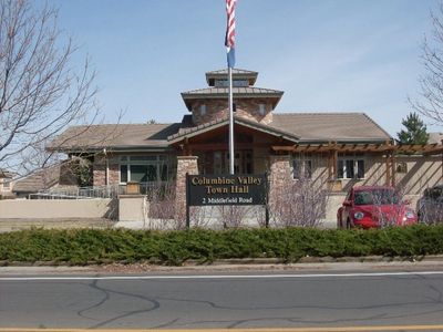 A Building With a Flag Post and an American Flag in the Font