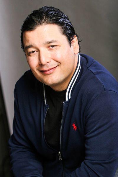 Smiling man in a navy jacket.