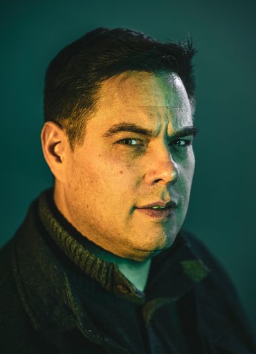 epic portrait of a man in teal lighting