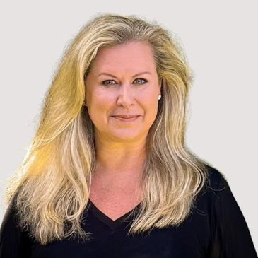 Confident woman with long blonde hair smiling slightly.