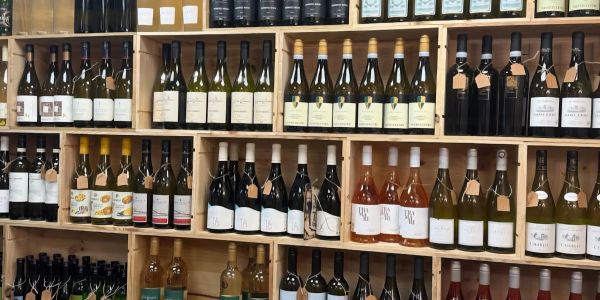 Wine bottles neatly arranged on wooden shelves.