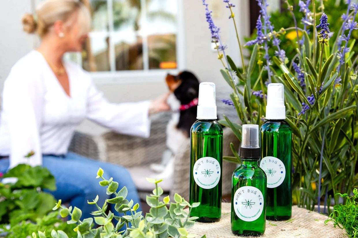 three bottles of green color and woman in background 