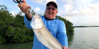 Key Largo inshore fishing charters. Man catching a redfish