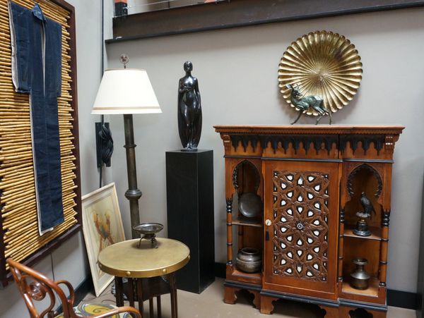 A room corner with vintage wooden cabinet and decorative items.