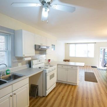 A kitchen with a ceiling fan