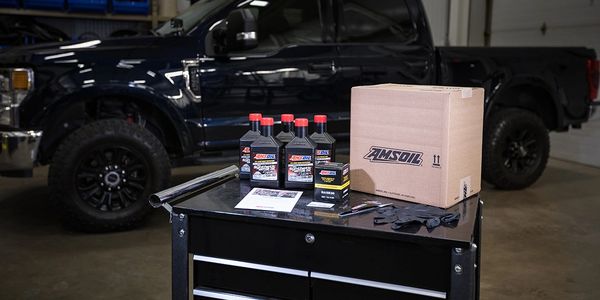 AMSOIL oil change kits include oil, filter, rubber gloves, and paper funnel.