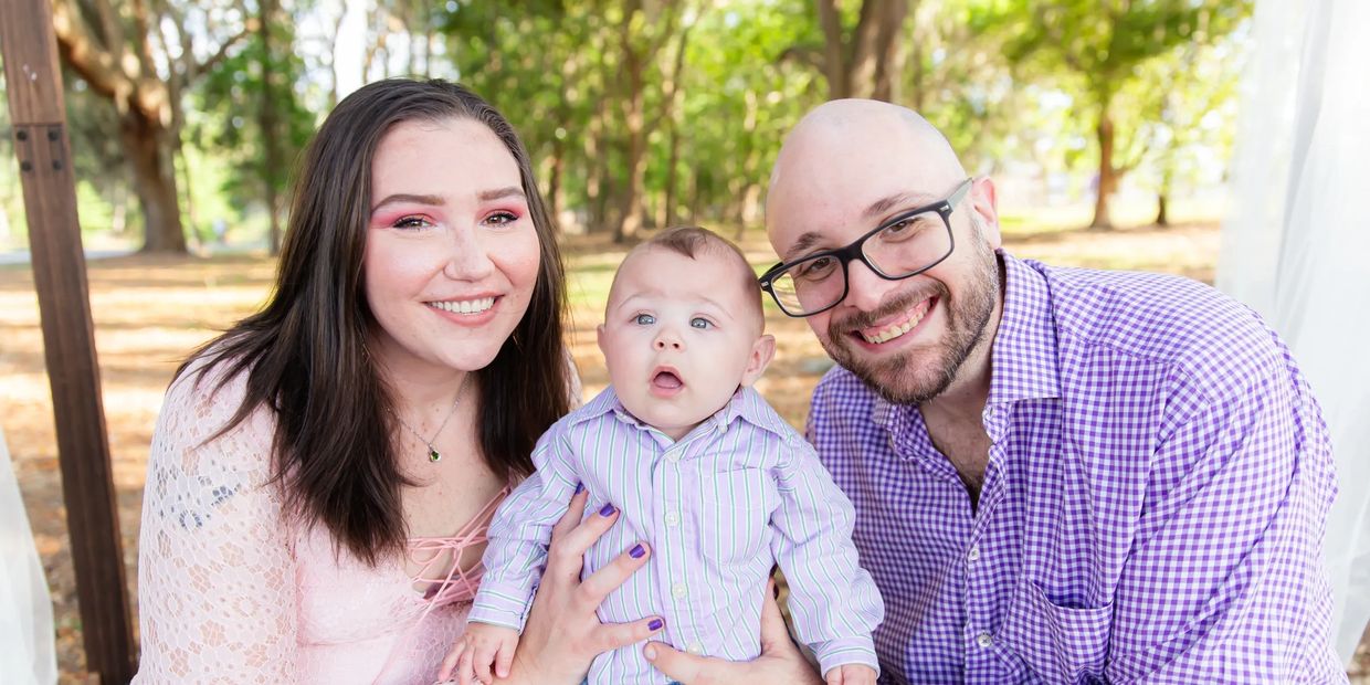 Happy family portrait in natural outdoor setting.