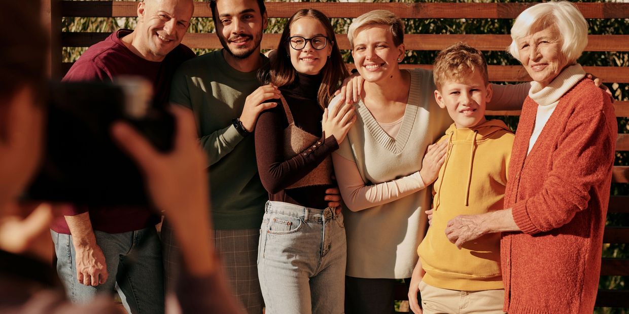 Happy family posing for a photo outdoors.