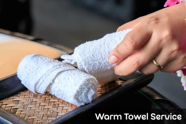 Placing warm towels on a spa tray for Oshibori service