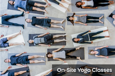 Group of people on yoga mats enjoy an on-site yoga and breathwork class