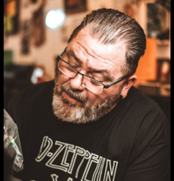 Co-founder of the tattoo and body shop at Vibe Body Art in the process of tattooing.
