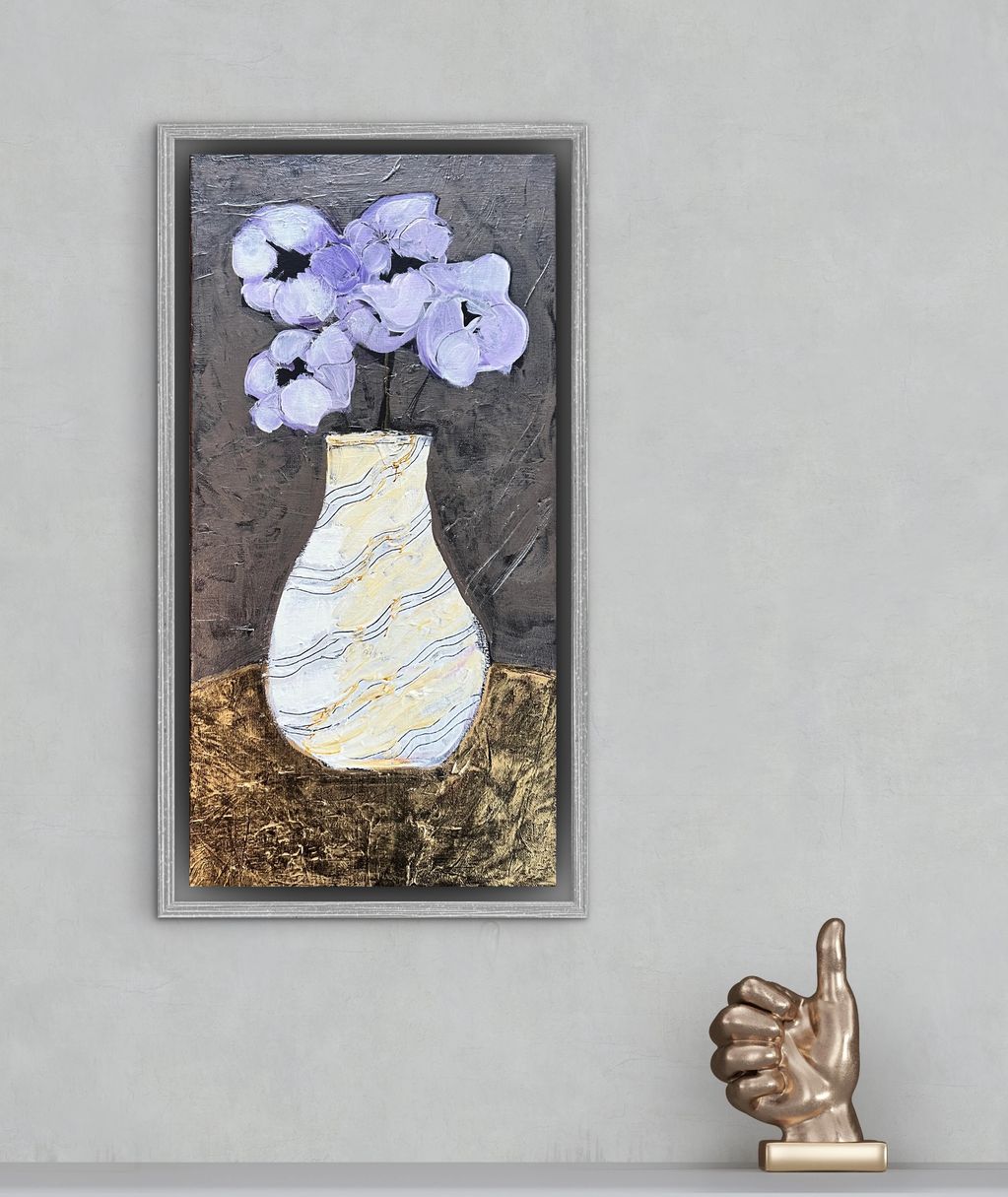 Abstract painting of purple flowers in a white vase with a bronze thumbs-up sculpture.