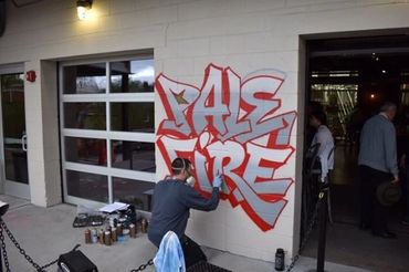 Street art style mural on a brick wall at Pale Fire Brewing.