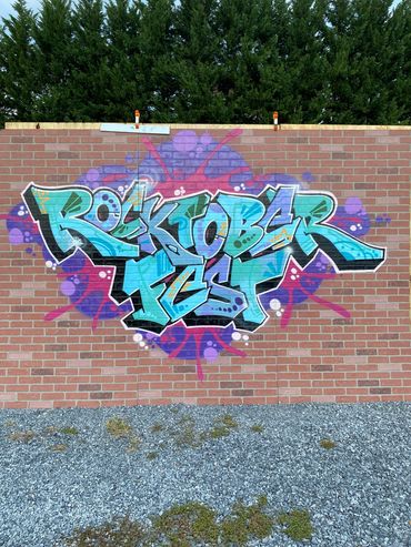 Street art style mural on brick wall for Rocktober Fest.