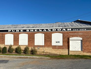 Large wall painting of logo for Pure Shenandoah.