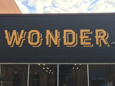 Large wall painting of logo for Wonder Skateshop.