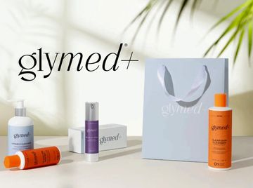 Glymed+ skincare products displayed with a branded gift bag.