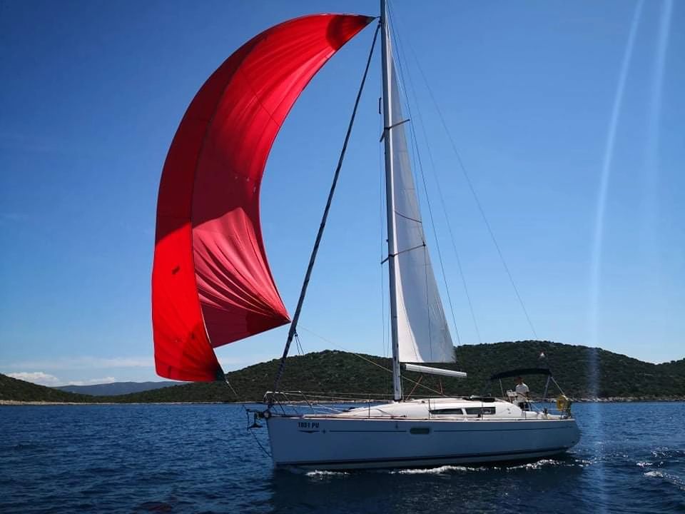sailing boat with red sail