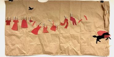 Clothesline art with red garments and black birds on brown paper background.