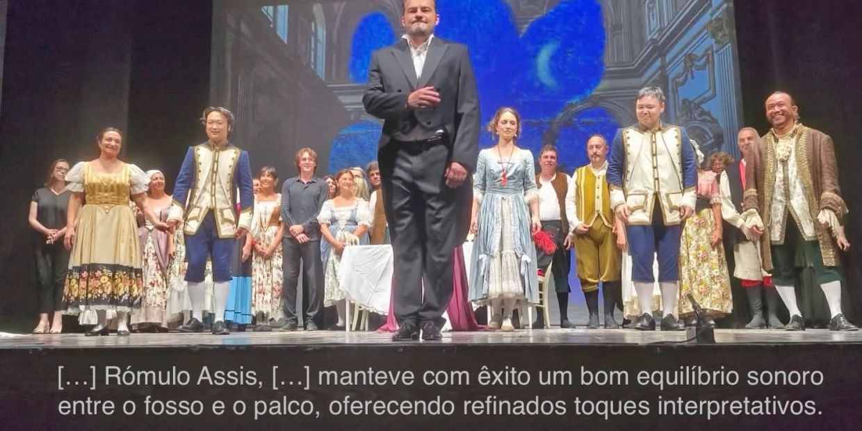 Elenco teatral faz reverência no palco.