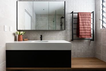 Matte black bathroom mixer and matte black shower rose.