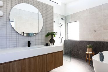 Matte black basin mixer and matte black shower rose in bathroom. 