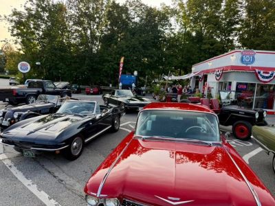 Vintage cars parked outside a retro diner.