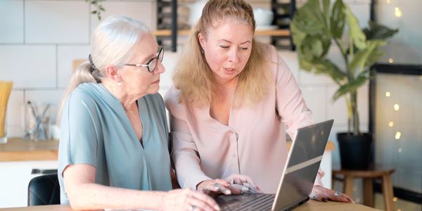 A woman is on her laptop trying to figure out what to do next and she gets help