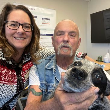 Sarita Shoemaker at her office with a client and his dog, Lefty.