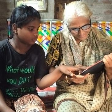 A girl teaching a woman