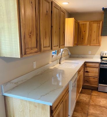 Clean kitchen countertop with wooden cabinets and modern appliances.