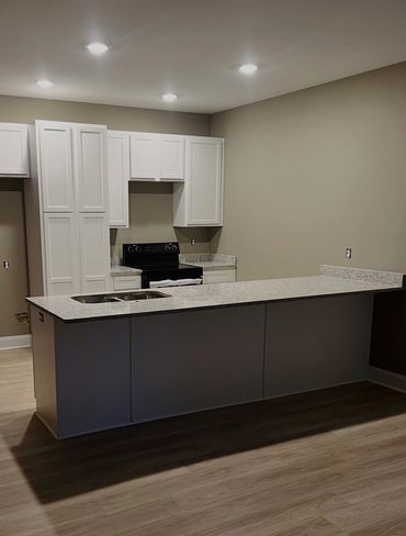 Modern kitchen with white cabinets and a large island counter.