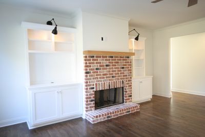 Modern Farmhouse rustic decor with white shaker cabinets, fireplace inspiration, brick, hardwood