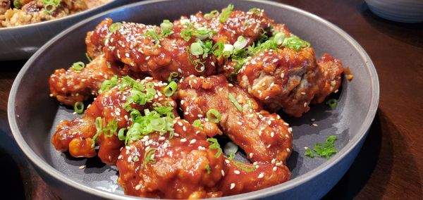 Korean fried chicken spicy gochujang garlic ginger sauce sesame seeds and scallions