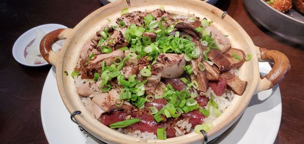 Clay pot rice or bo zai fan in Cantonese with chicken, mushrooms and chinese sausage.