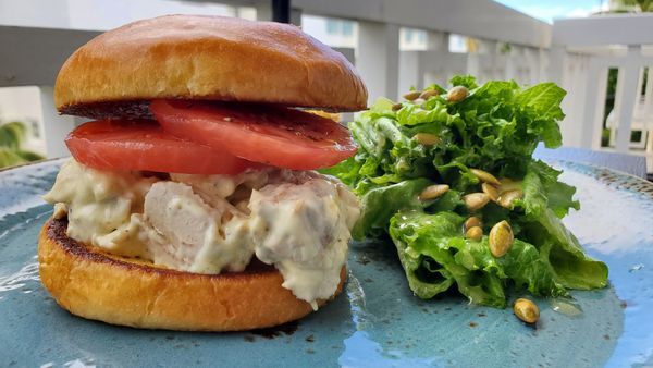 Tuna salad sandwich made with fresh caught blackfin tuna, homemade kewpie w tomato on a brioche bun