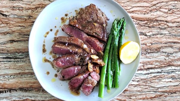 ribeye steak dinner cheap beef dry aged pan seared brown butter asparagus garlic beef boneless