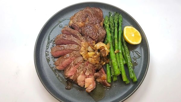 Sous vide ribeye steak dinner under $10 budget friendly dinner beef asparagus garlic shallots butter